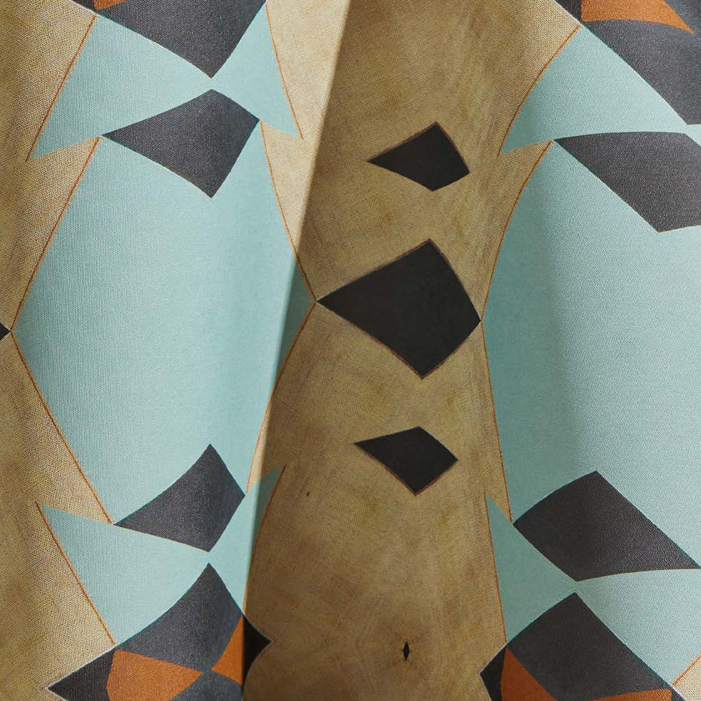 Draped wallpaper yardage in a large-scale triangle print in shades of blue, tan and gray.