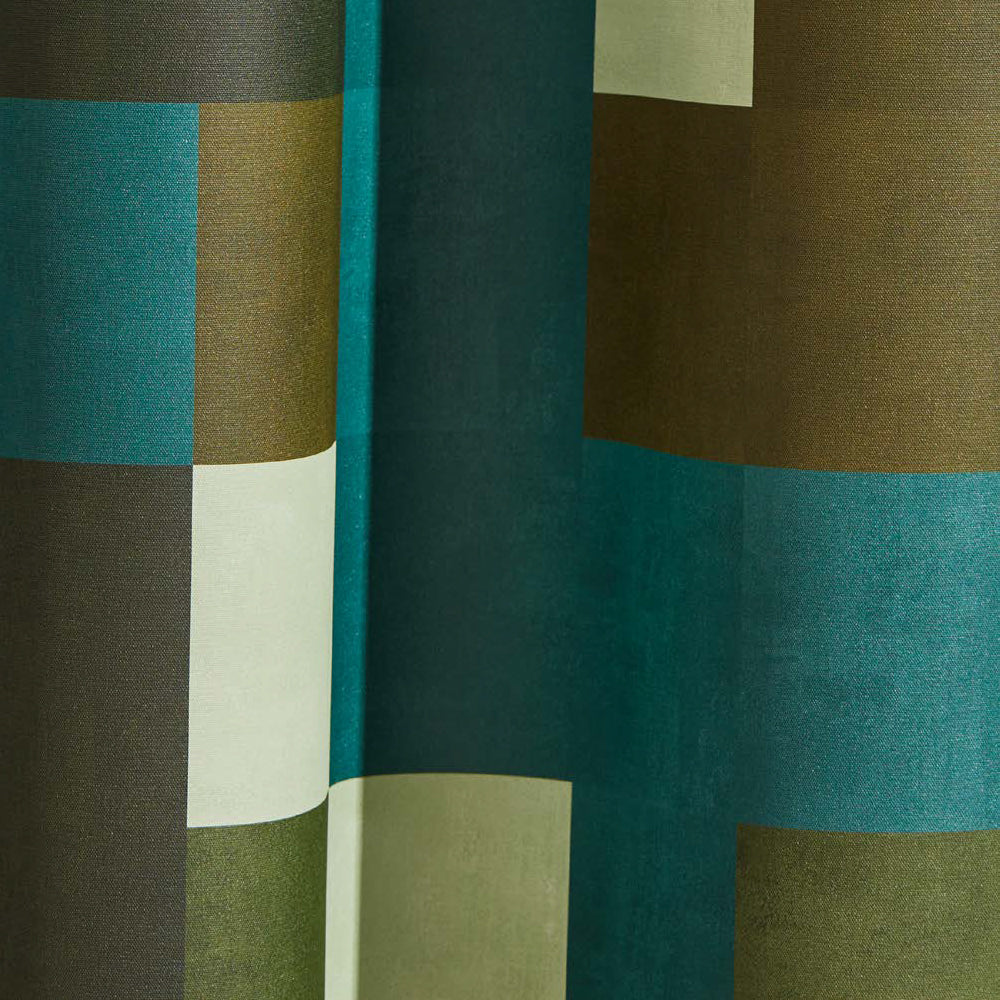 Draped wallpaper yardage in an interlocking square pattern in shades of turquoise, green and cream.