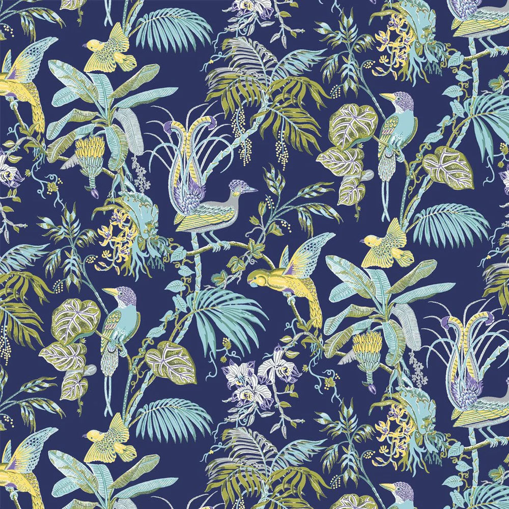 Detail of fabric in a dense leaf and bird print in shades of yellow and blue on a navy field.