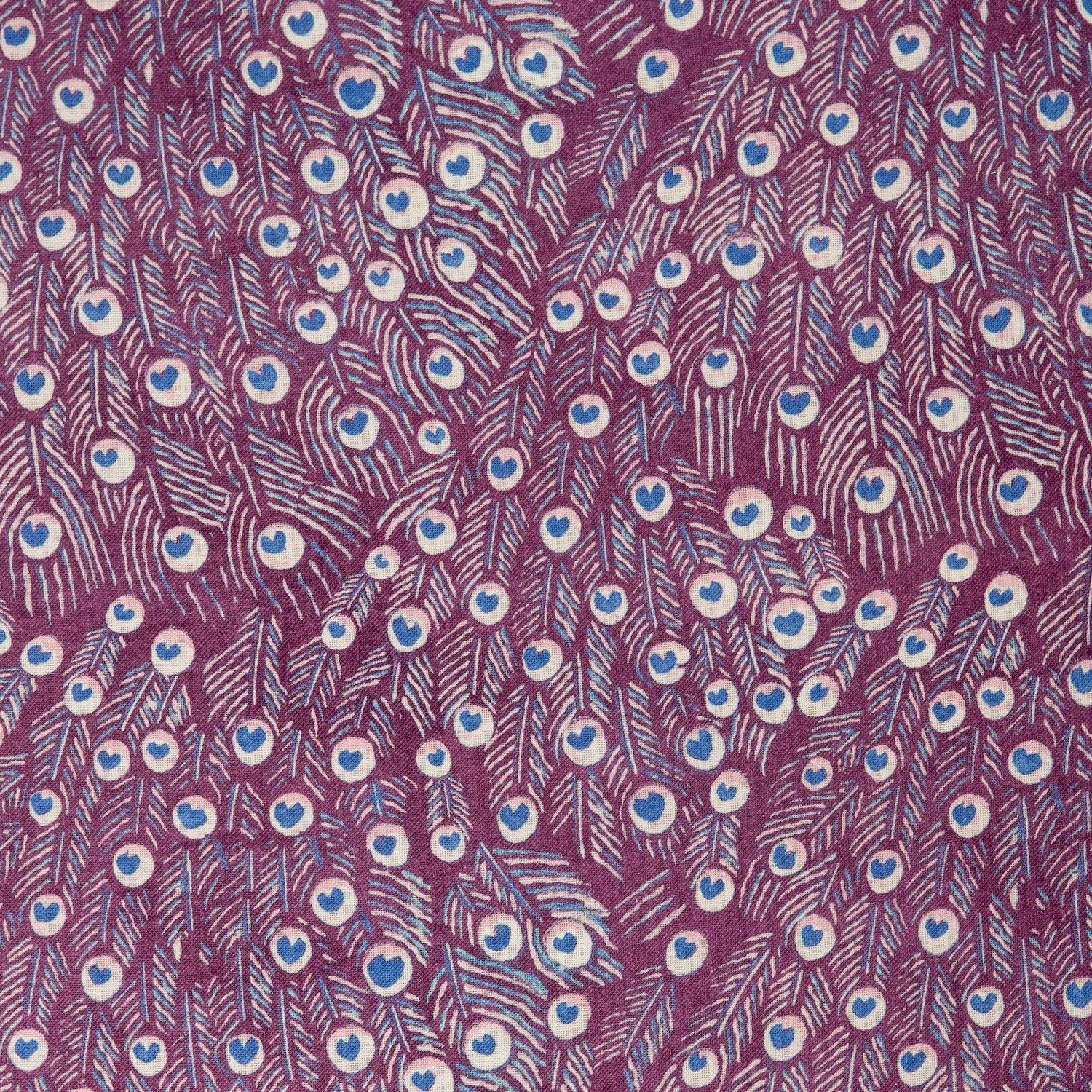 Detail of a linen fabric in a peacock feather pattern in pink and blue on a maroon field.