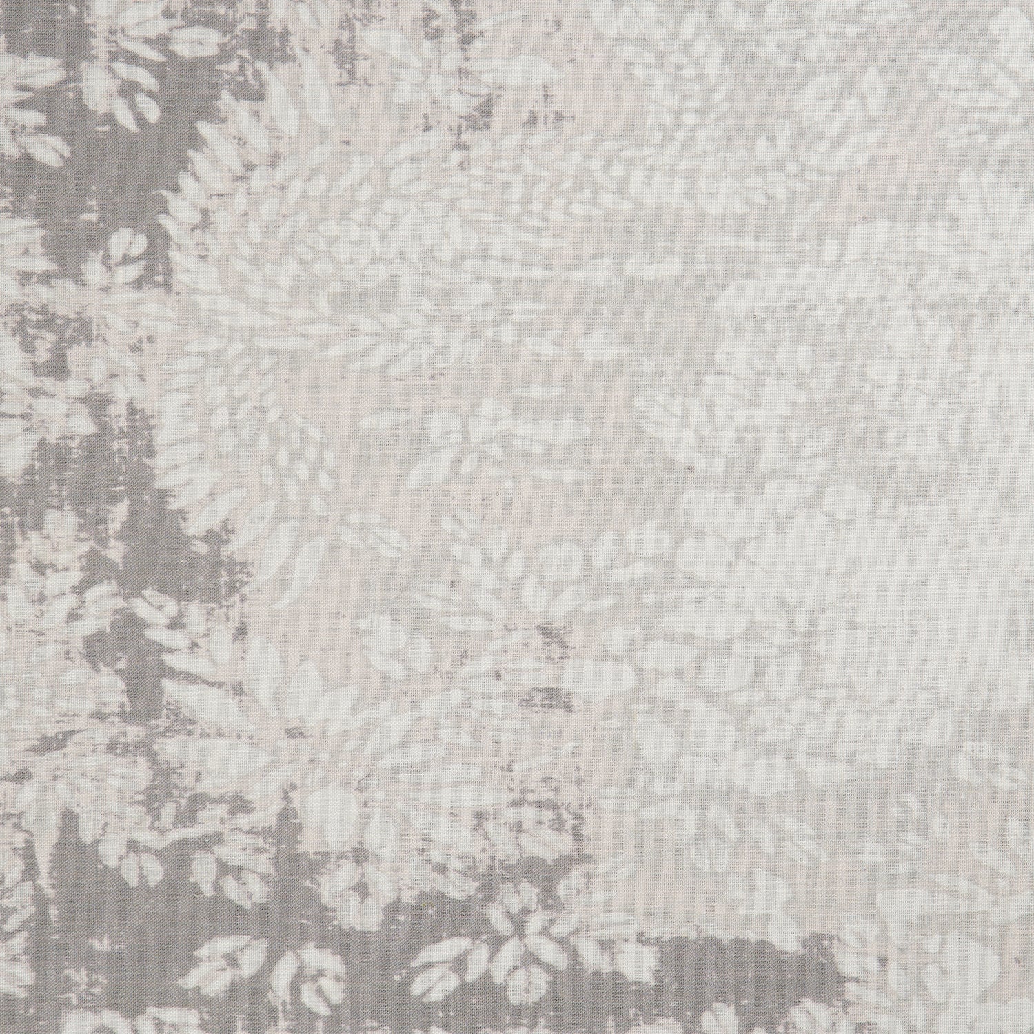 Detail of a linen fabric in a floral and leaf pattern in white on a mottled beige and gray field.