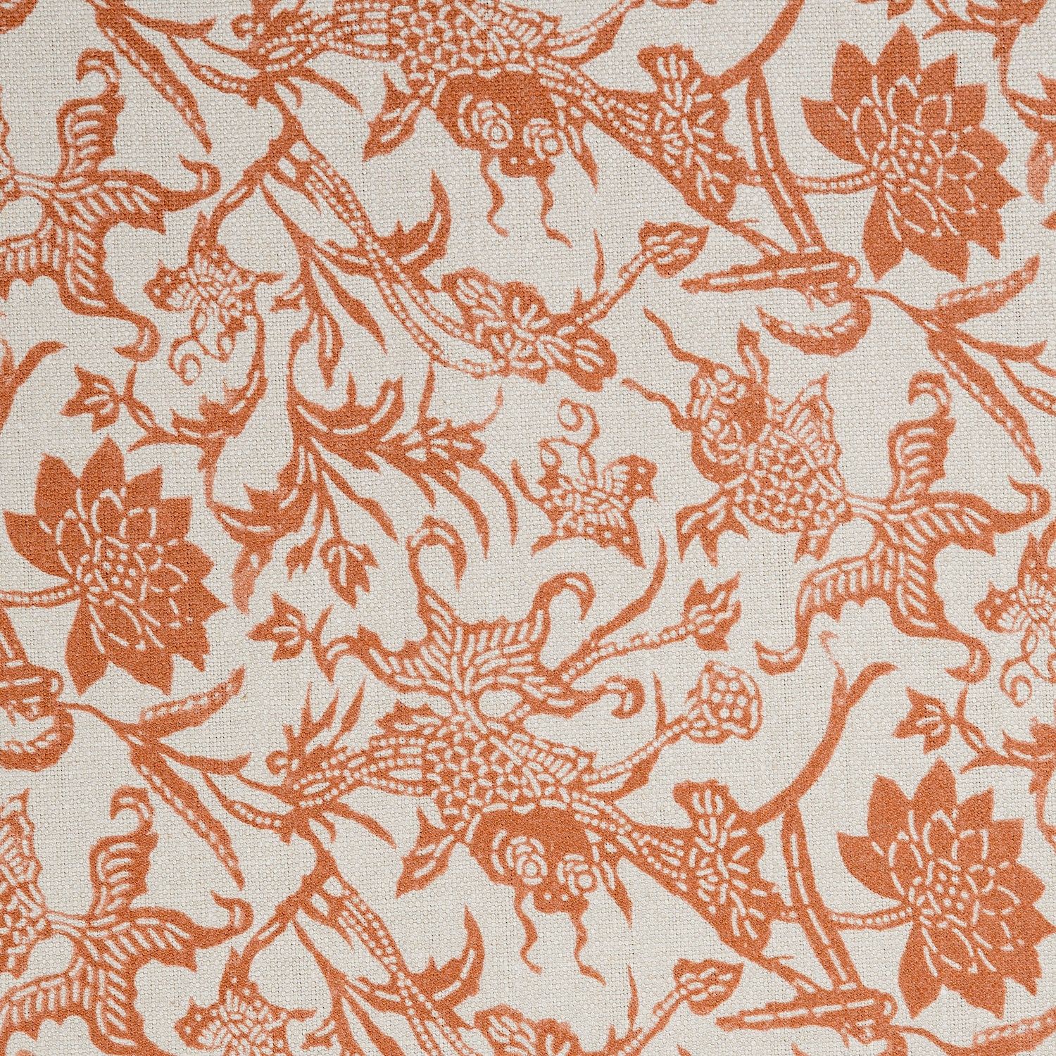 Detail of a linen fabric in a carp and leaf pattern in orange on a beige field.