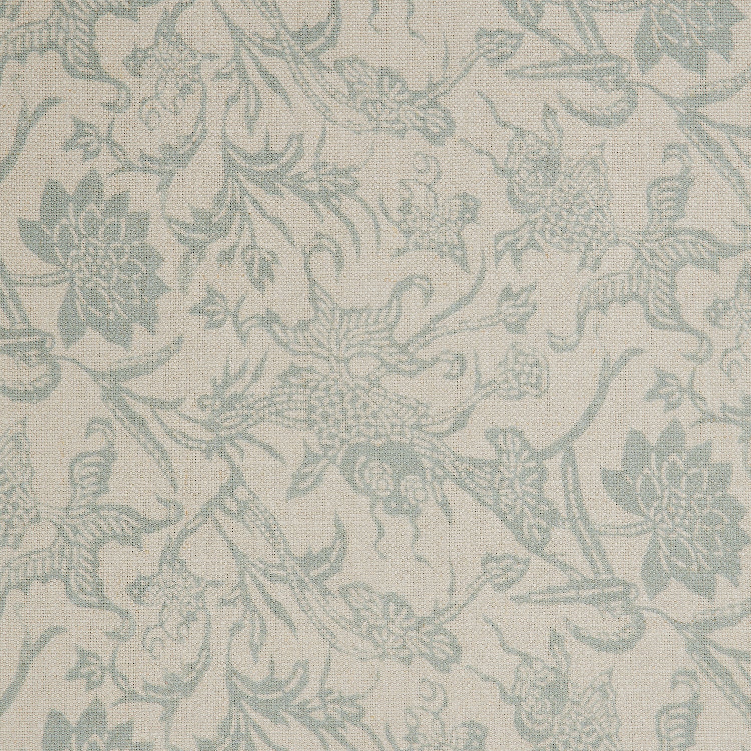 Detail of a linen fabric in a carp and leaf pattern in misty blue on a beige field.