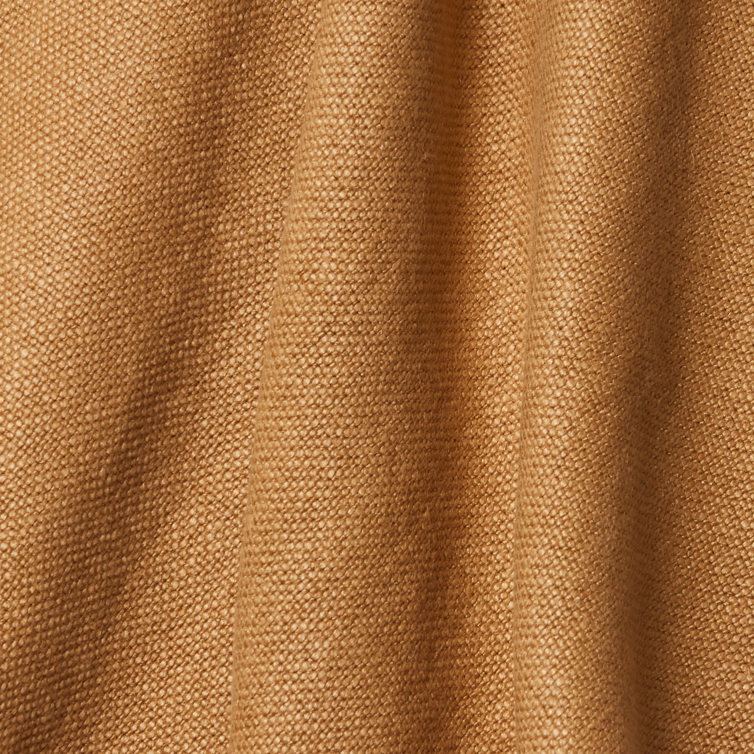 A draped swatch of old-world linen fabric in a solid tan color.