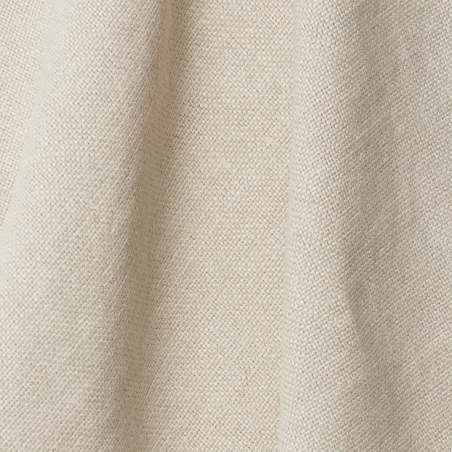 A draped swatch of old-world linen fabric in a solid cream color.
