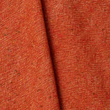 A draped swatch of blended linen-wool mix fabric in a flecked red color.