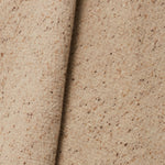 A draped swatch of blended linen-wool mix fabric in a flecked tan color.