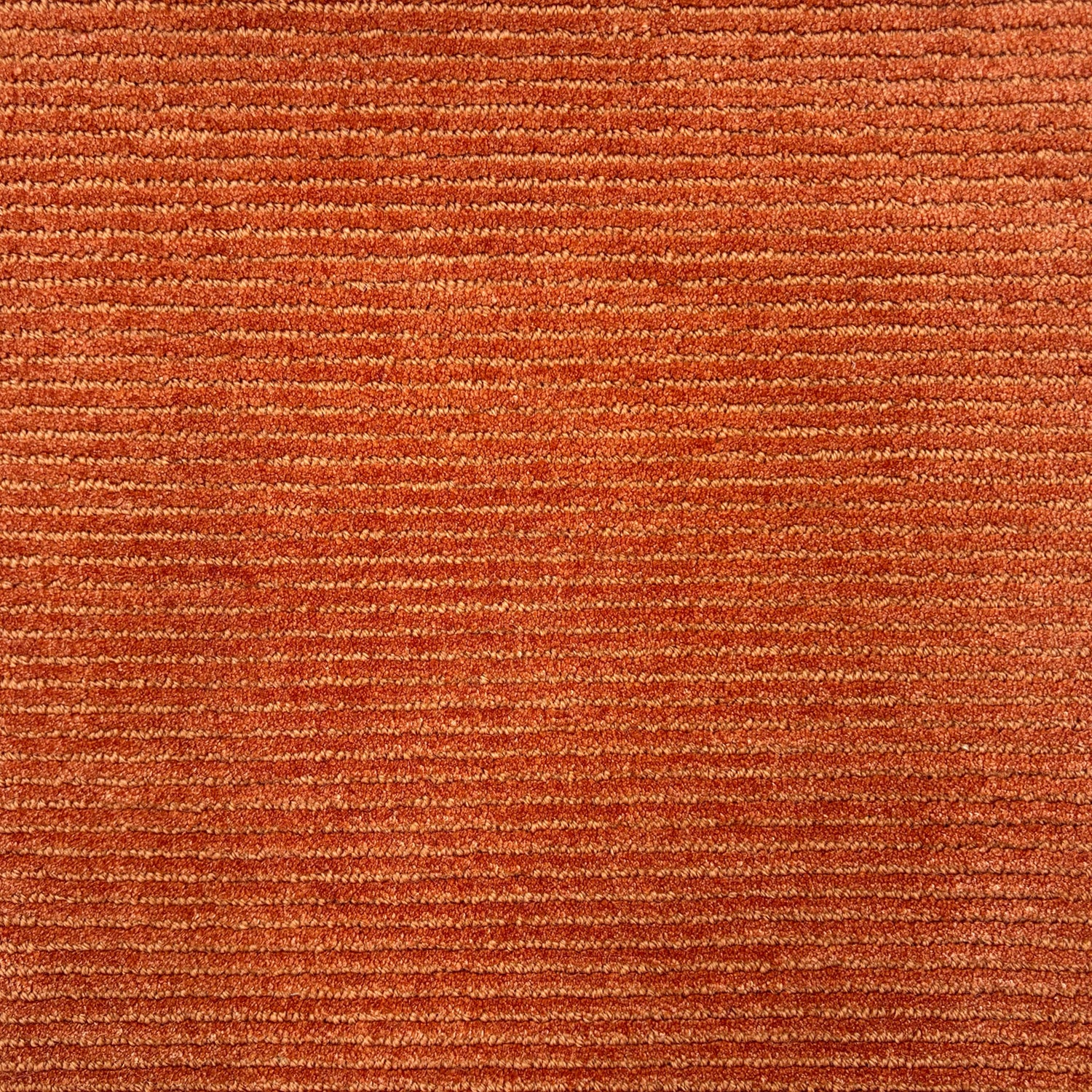 Detail of a handtufted orange rug with a subtle ribbed stripe