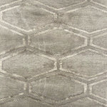 Detail of handknotted rug in grey featuring a hexagon lattice pattern