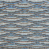 Detail of handwoven rug in a wavy striped pattern in shades of blue and tan.