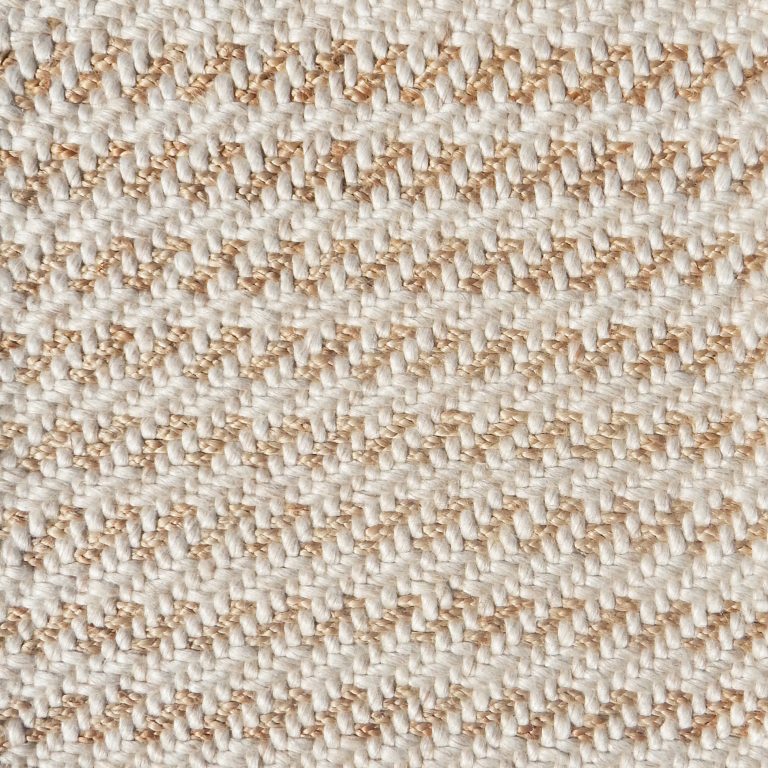 Detail of a textural rug in natural fiber and cream yarn.