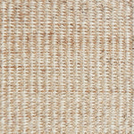 Detail of a textural rug in natural fiber and cream yarn.