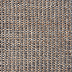Detail of a textural rug in natural fiber and grey yarn.