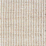 Detail of a textural rug in natural fiber and white yarn.