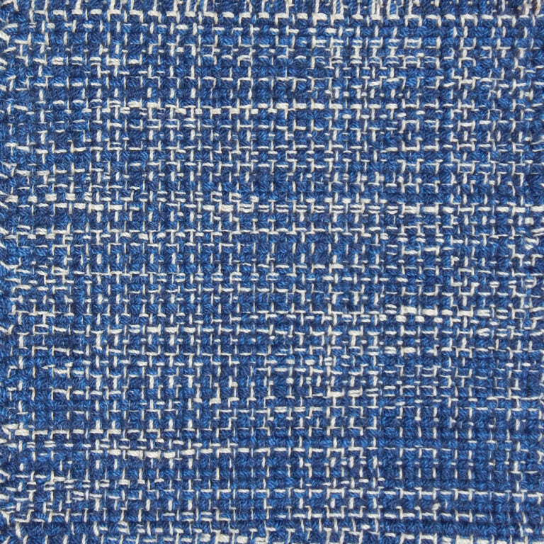 Detail of a flatweave with a strié effect in blue and white