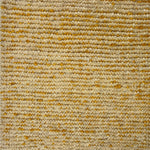 Detail of a wool rug in a textural weave in yellow