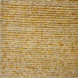 Detail of a wool rug in a textural weave in yellow