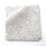 Fabric swatches in a painterly branch print in white on an ecru watercolor field.