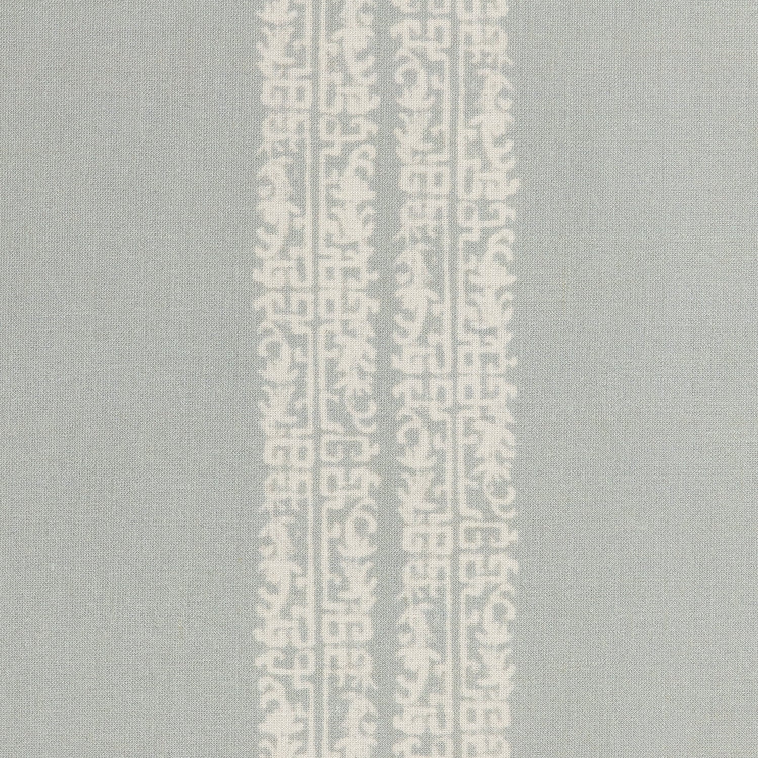 Detail of a linen fabric in a scrolling floral stripe pattern in cream on a light blue-gray field.
