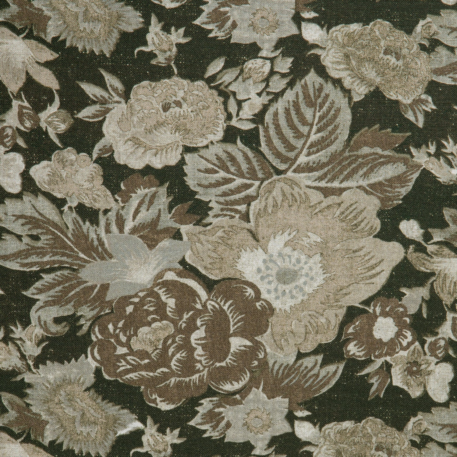 Detail of a linen fabric in a detailed floral pattern in shades of beige and brown on a black field.