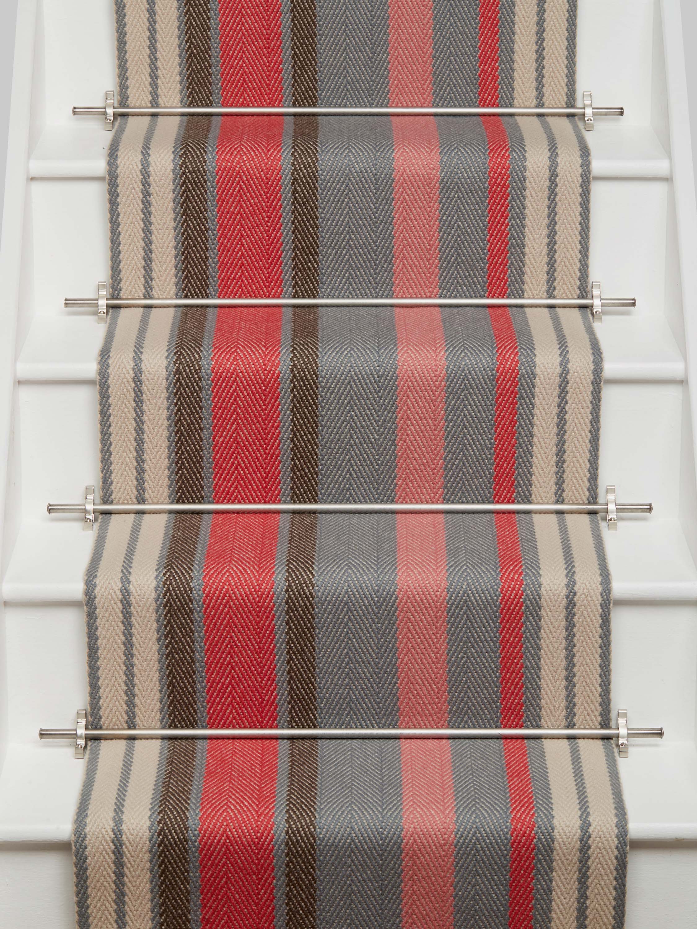Striped flatweave runner in pink red grey and cream on white staircase