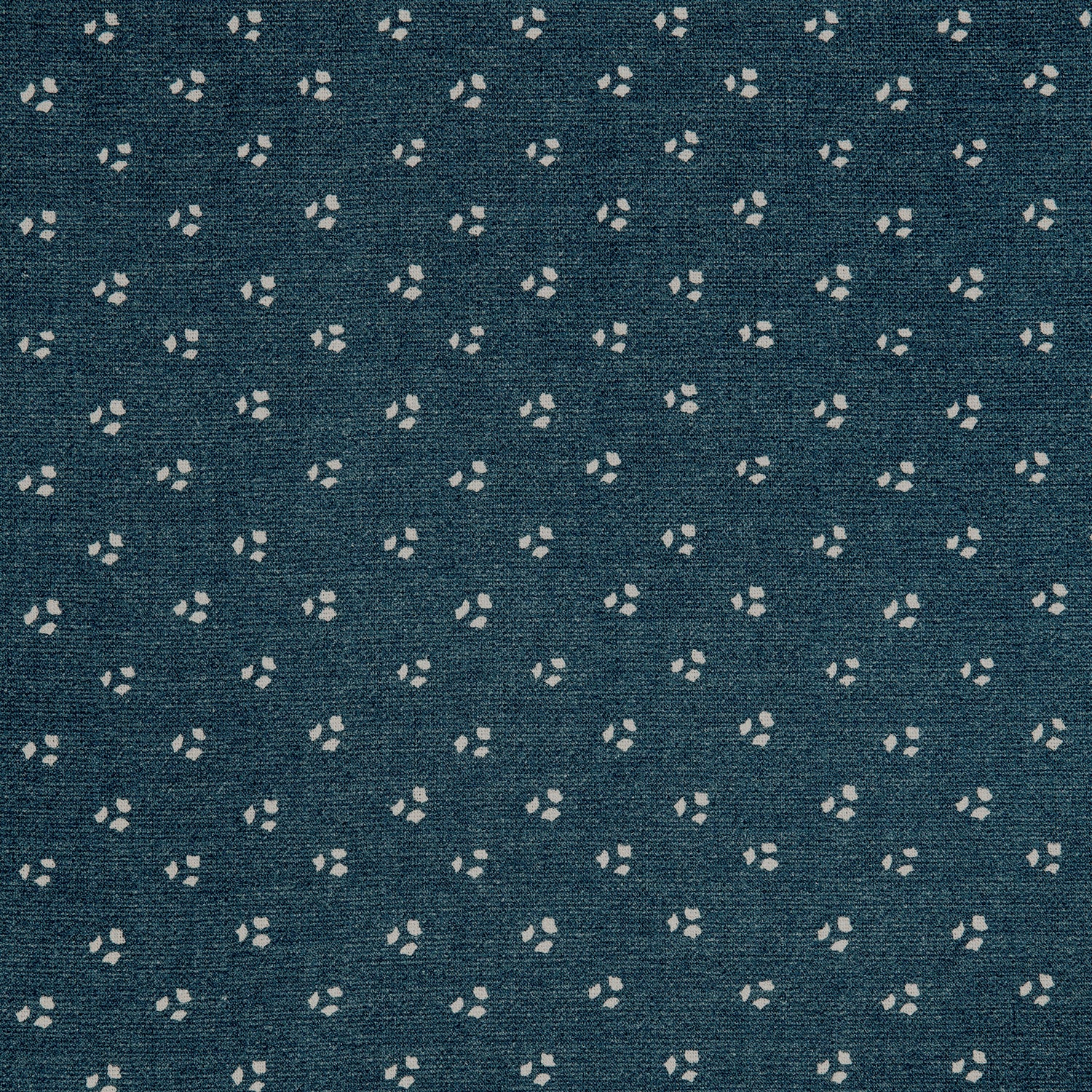 Detail of a linen fabric in a clustered dot pattern in cream on an indigo field.