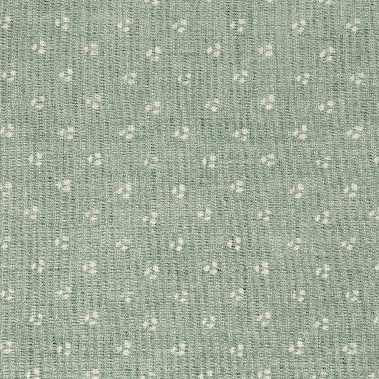 Detail of a linen fabric in a clustered dot pattern in cream on a sage field.
