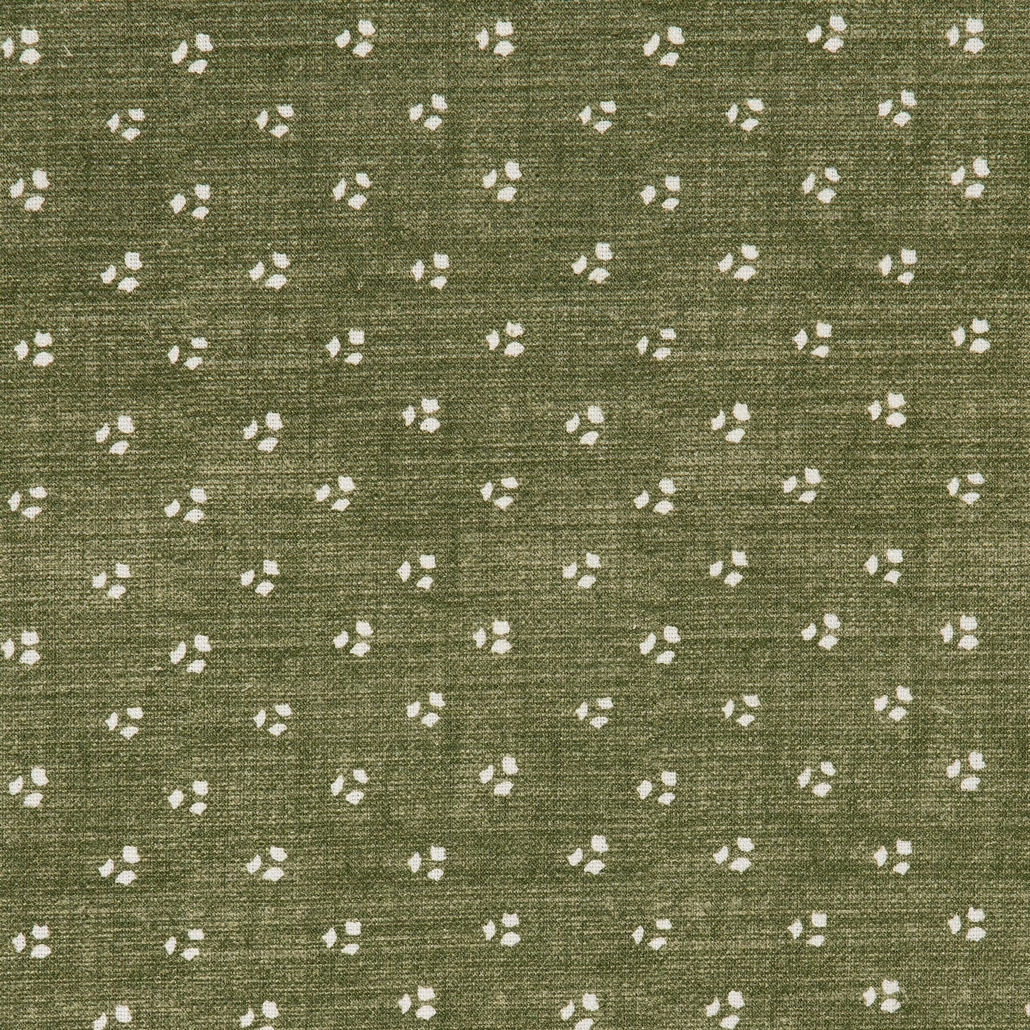 Detail of a linen fabric in a clustered dot pattern in cream on a moss field.