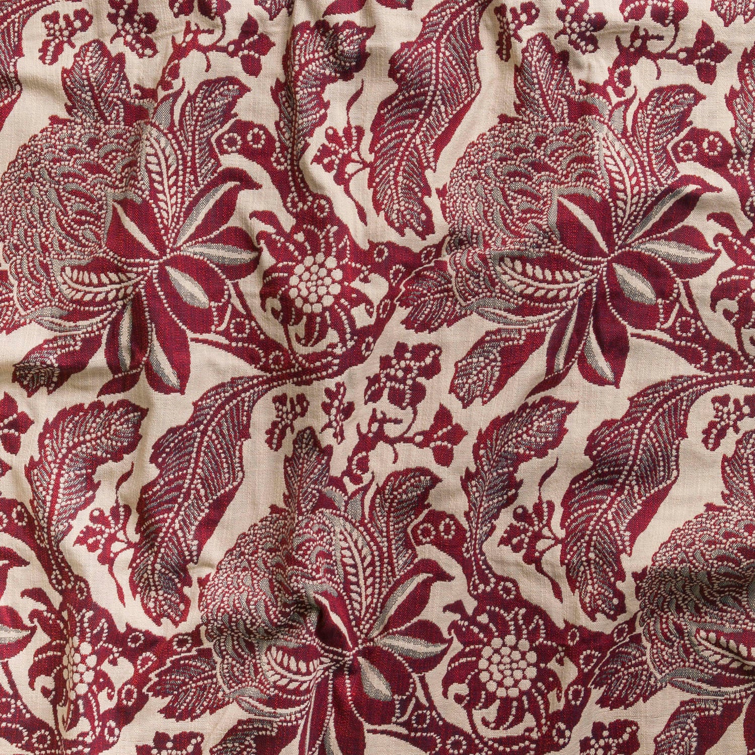 Detail of wallpaper in a repeating botanical print in maroon and gray on a cream field.