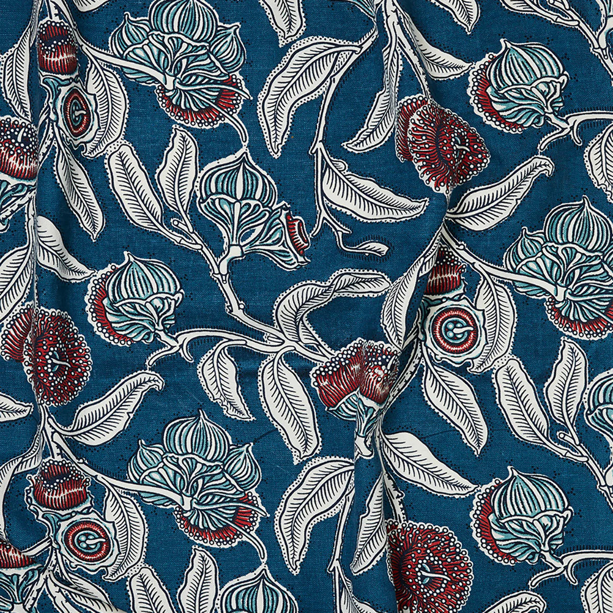 Draped fabric in a painterly floral print in blue, white and red on a navy field.