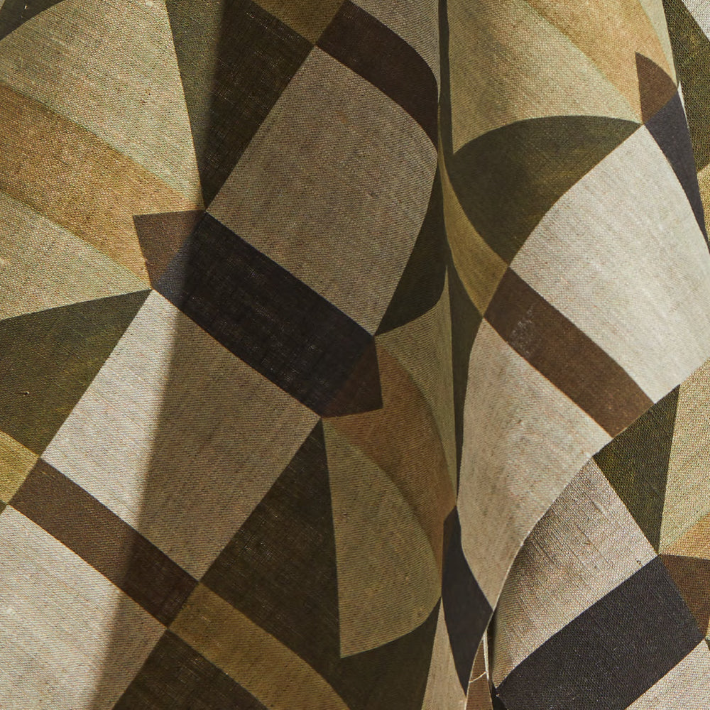 Draped fabric yardage in a large-scale geometric grid in shades of brown and tan.