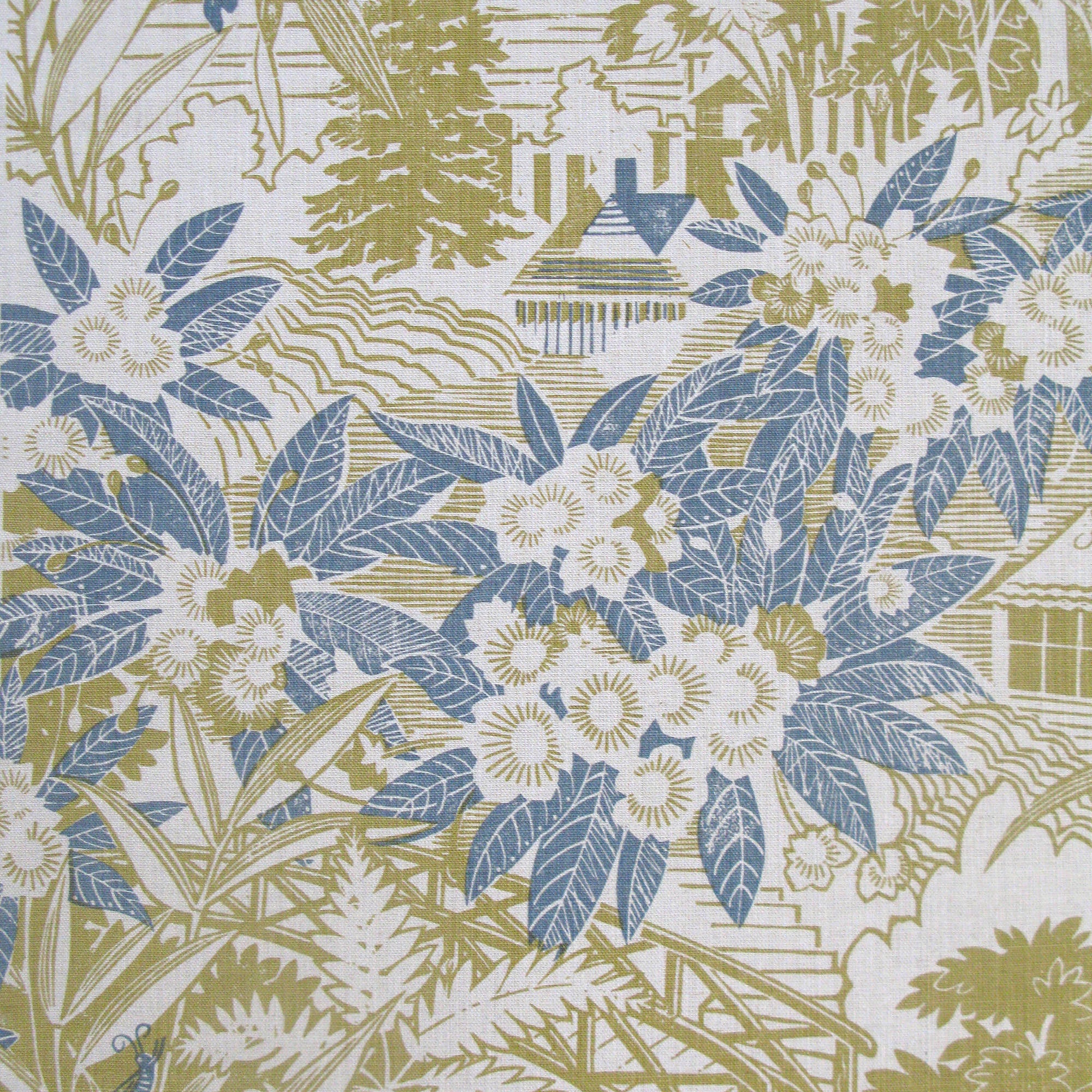 Detail of fabric in an intricate botanical, bridge and house print in blue and green on a cream field.