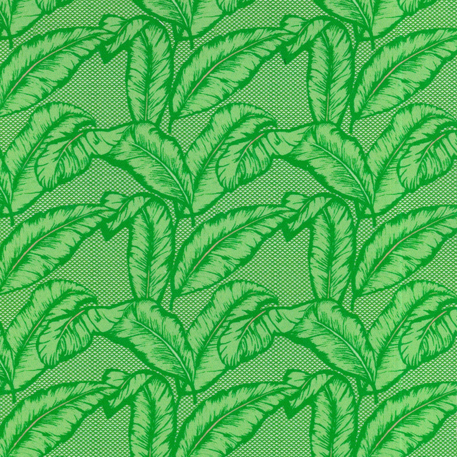 Detail of fabric in a dense leaf print in shades of green on a green field.