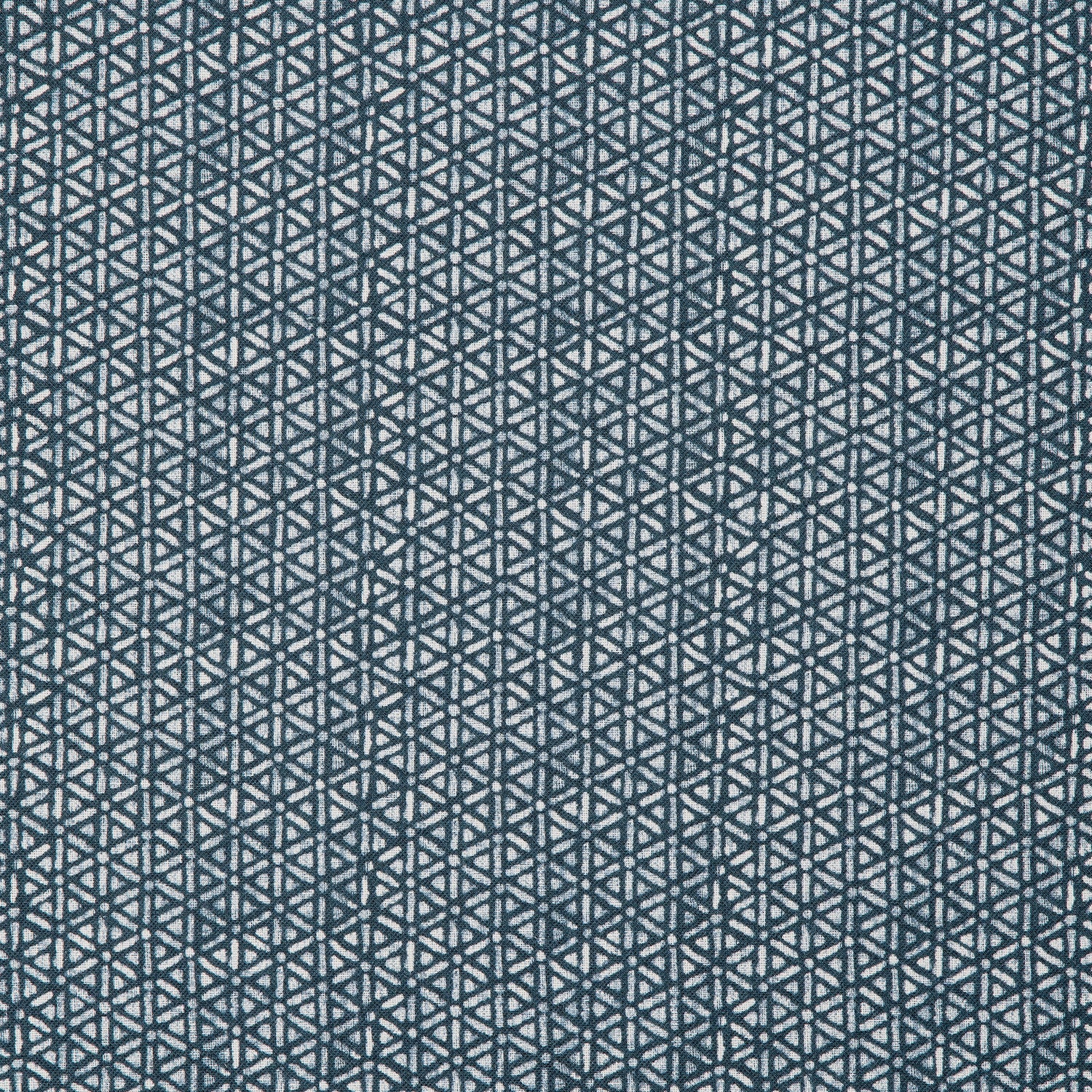 Detail of a linen fabric in a detailed geometric pattern in white on an indigo field.