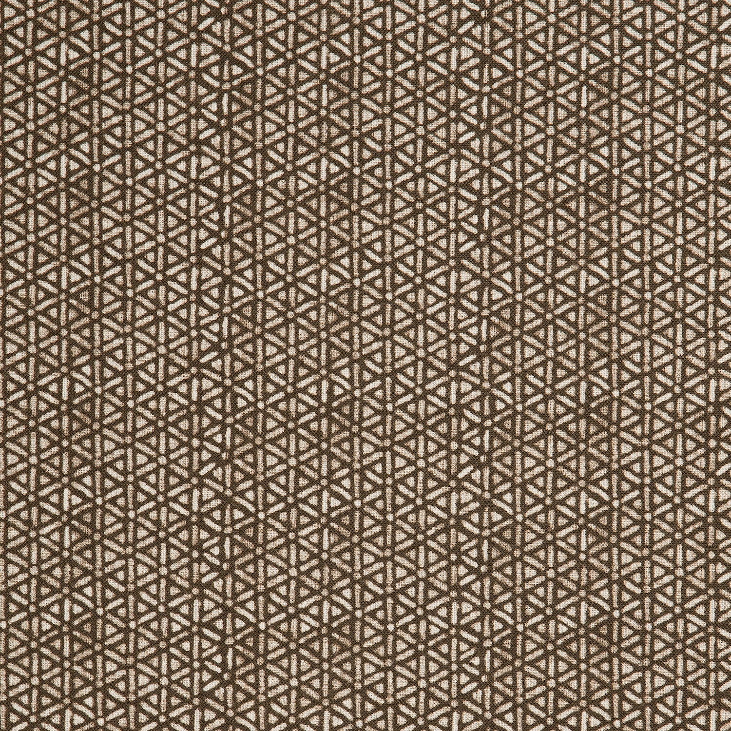 Detail of a linen fabric in a detailed geometric pattern in white on a dark brown field.