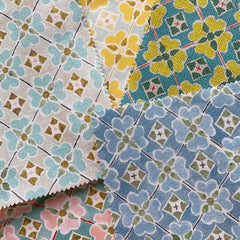 Overlapping square swatches of woven fabric in five different colorways of the same vintage-inspired floral grid pattern.