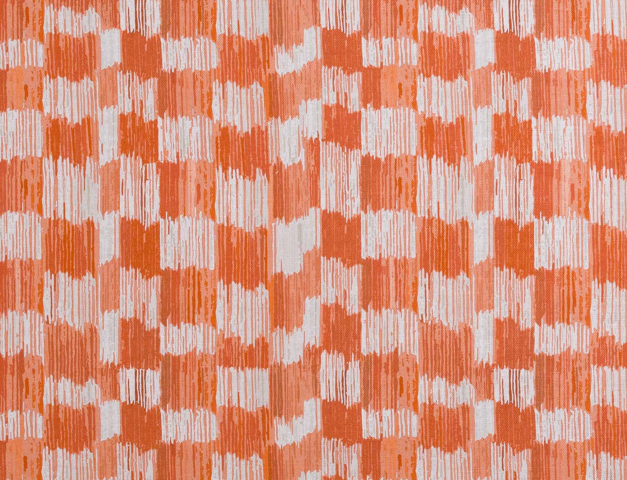 Detail of fabric in an abstract check print in shades of red, coral and white.