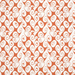 Detail of fabric in a playful abstract shape print in white on a burnt orange field.