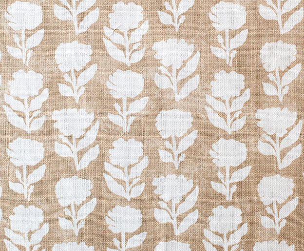 Detail of fabric in a classic floral silhouette print in cream on a taupe field