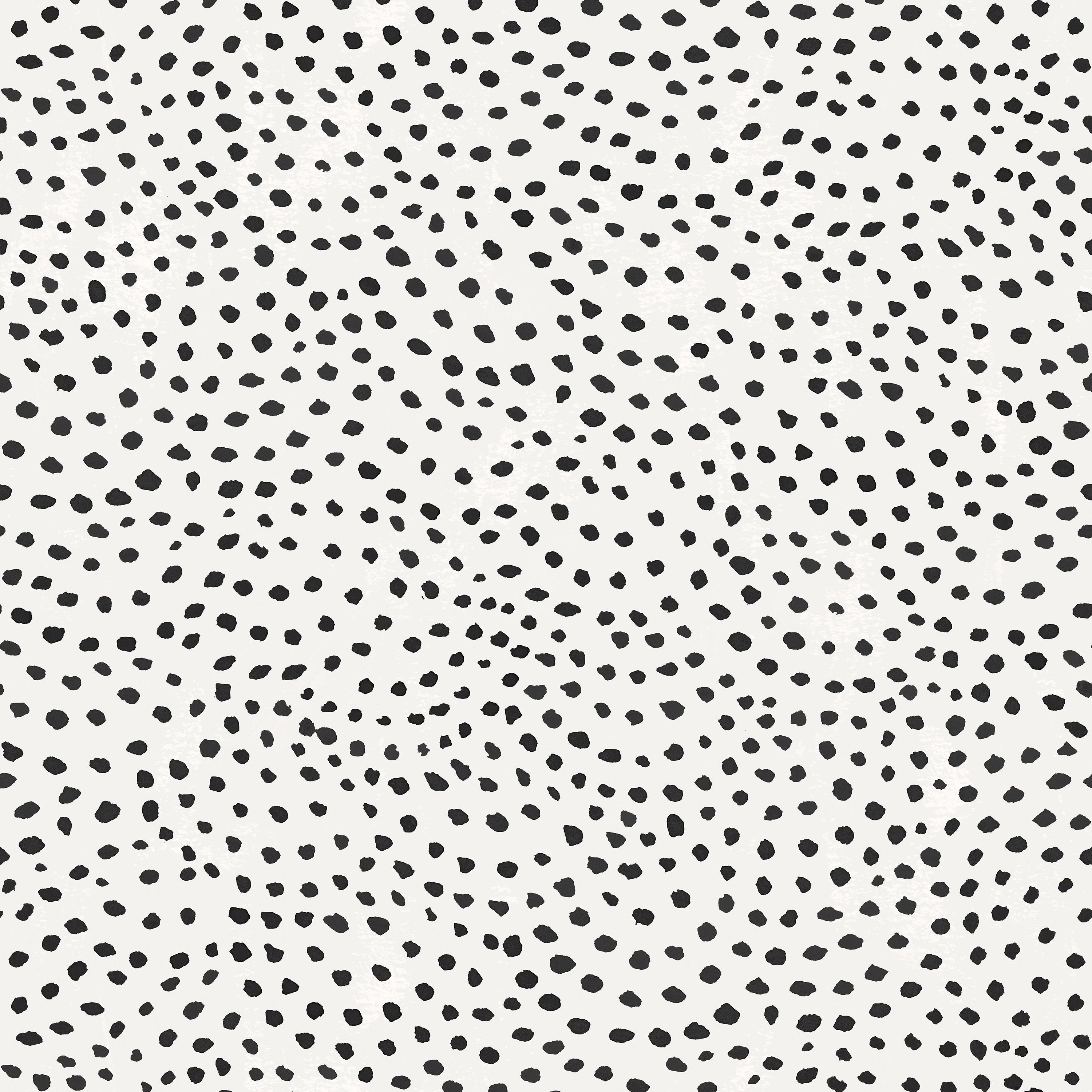Detail of wallpaper in a scalloped dot print in black on a cream field.