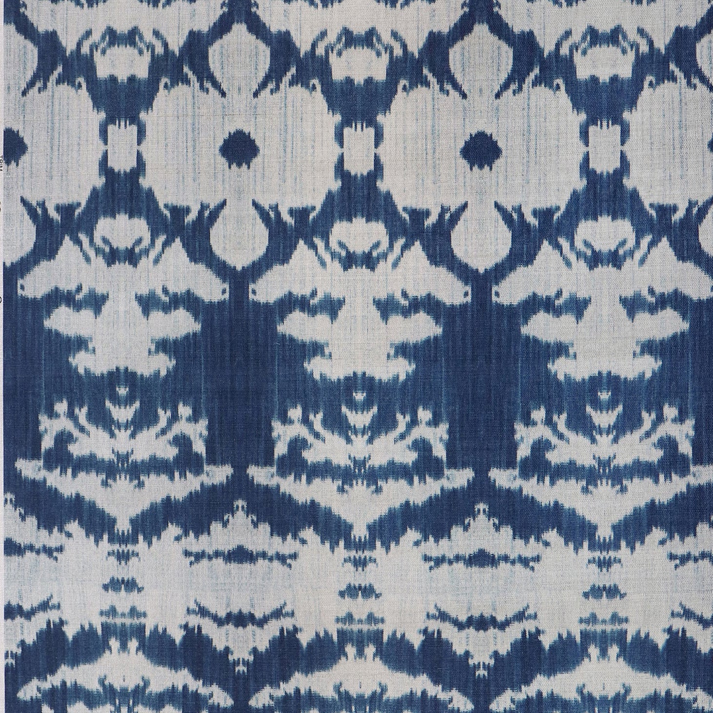 Detail of wallpaper in an ikat pattern in blue and greige.