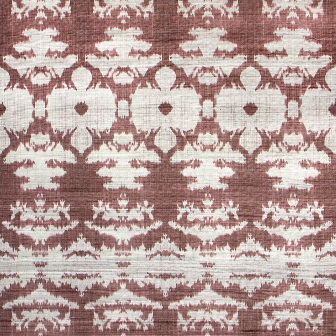 Detail of wallpaper in an ikat pattern in rust and tan.