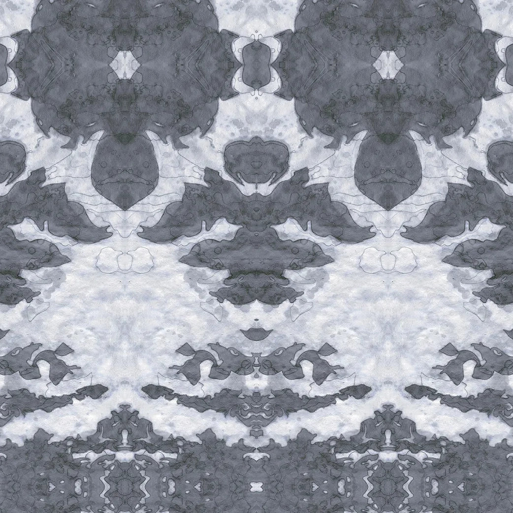 Detail of wallpaper in a painterly ikat print in shades of gray and light blue.