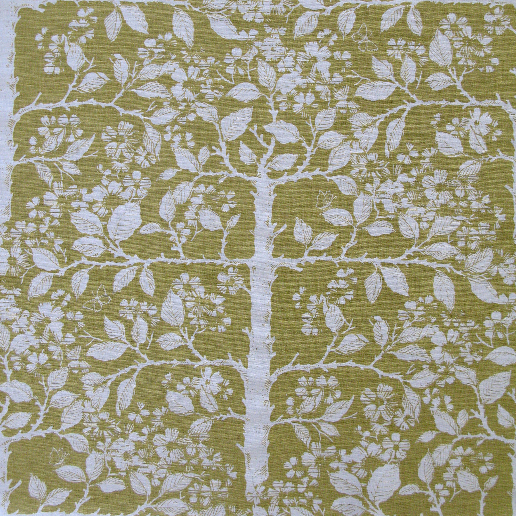 Detail of fabric in a large-scale tree and leaf print in white on an olive field.