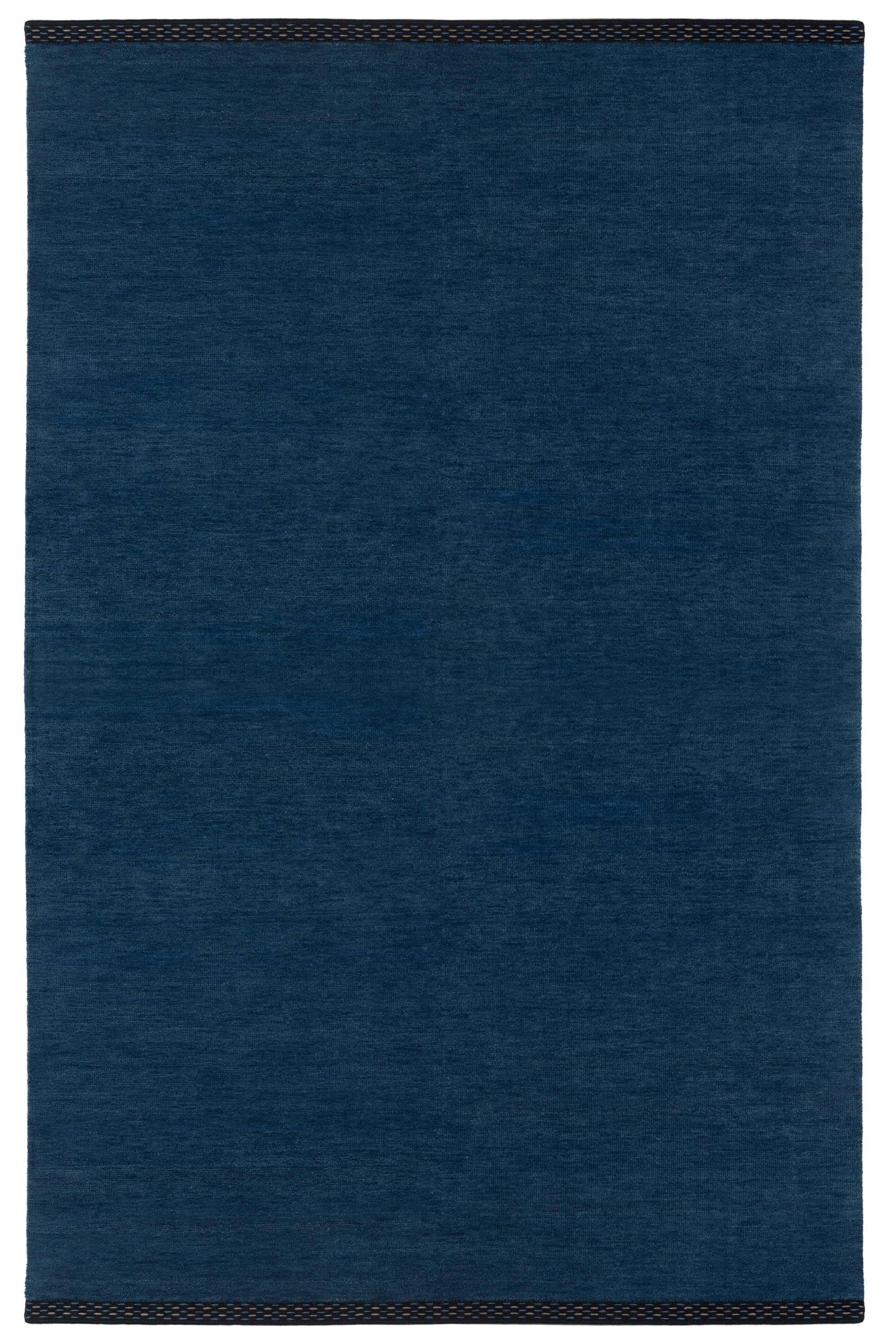 Full Size Plain Stitched Border Rug in Prussian Blue, a solid indigo rug with a black border with black border with blue and taupe dashes. 