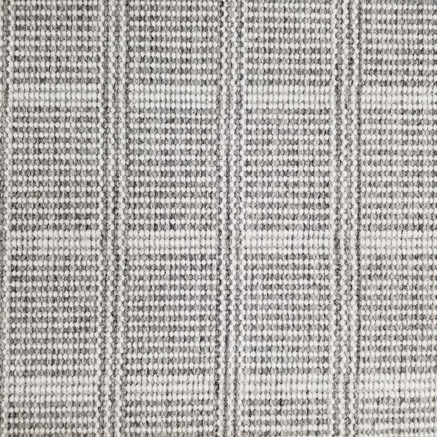 Wool broadloom carpet swatch in a plaid print in shades of gray and white.