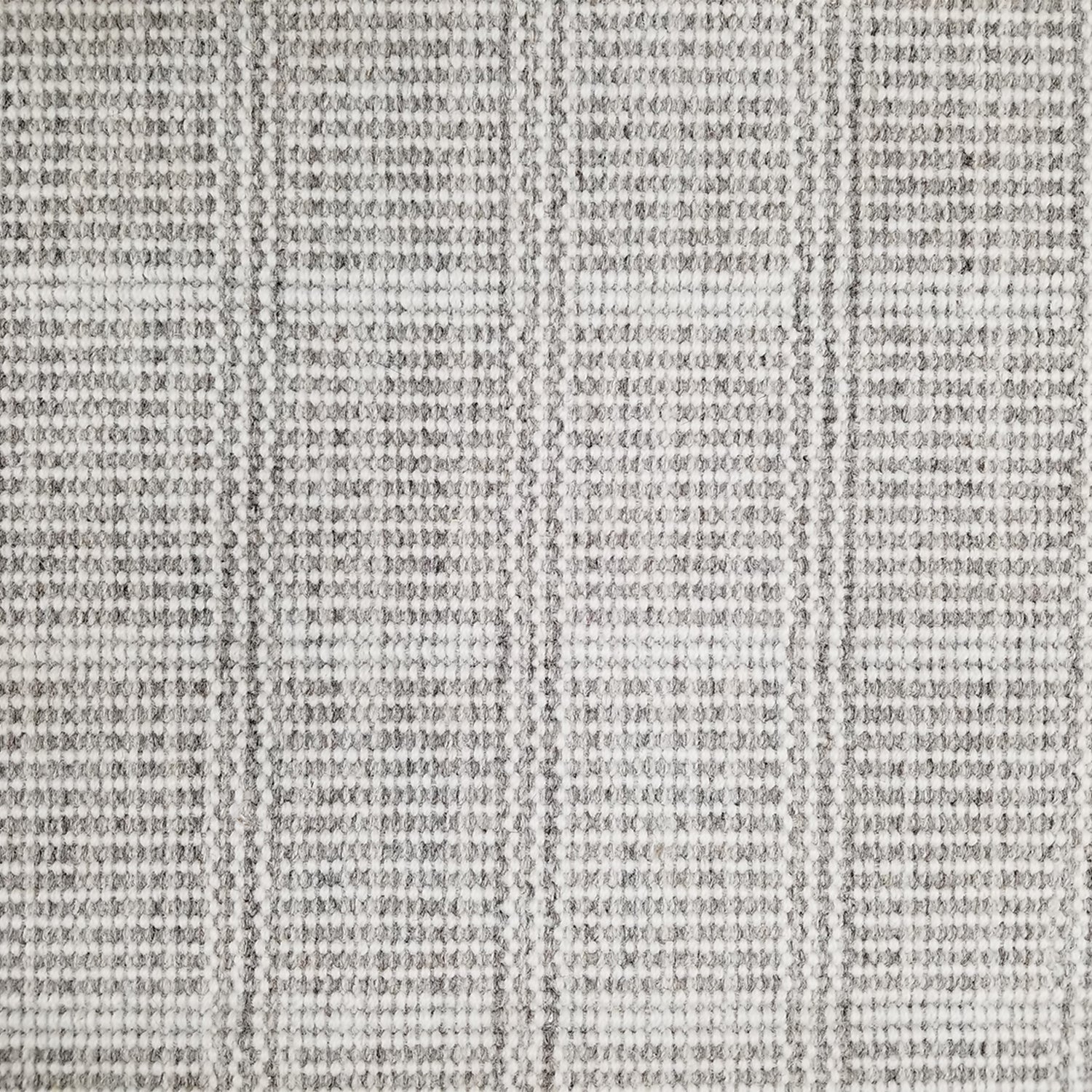 Wool broadloom carpet swatch in a plaid print in shades of gray and cream.