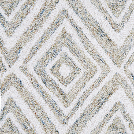 Wool broadloom carpet swatch in a painterly diamond pattern in white and tan speckled with blue.