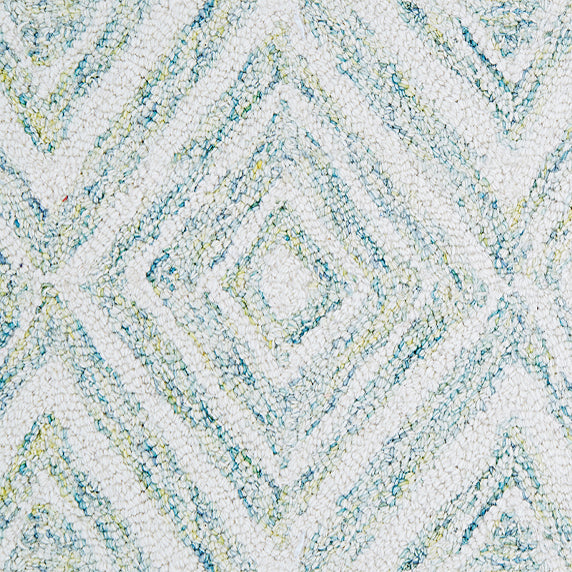 Wool broadloom carpet swatch in a painterly diamond pattern in white and blue speckled with lime green.