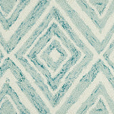 Wool broadloom carpet swatch in a painterly diamond pattern in cream and blue speckled with turquoise.